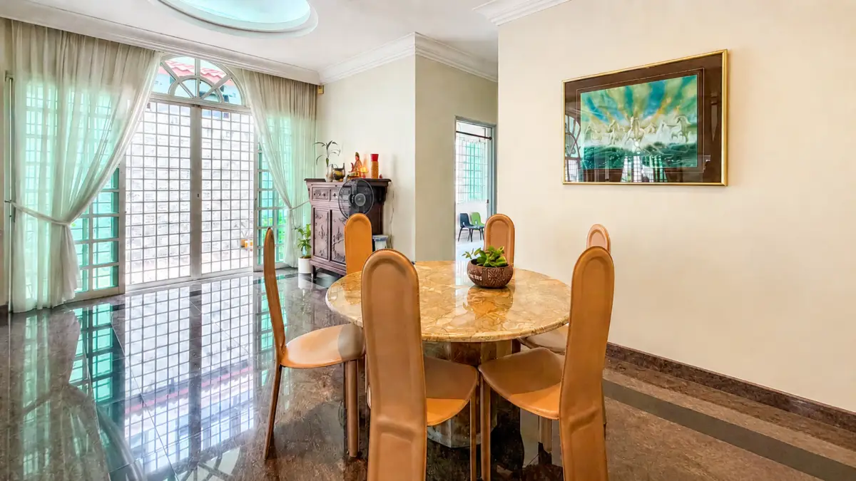 Bright dining room with a round marble table and tan leather chairs, glass doors with sheer curtains, and a decorative cabinet.