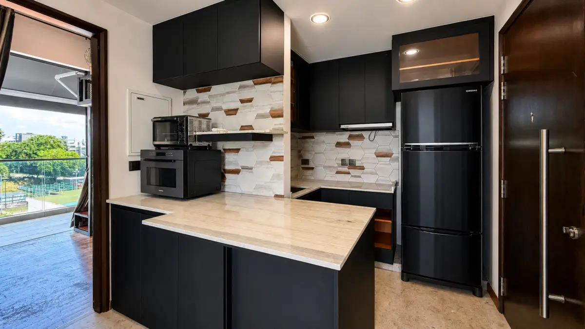 Modern black kitchen with marble island, built-in oven, microwave, and a tall black Samsung fridge; hex tile backsplash and dark cabinets.