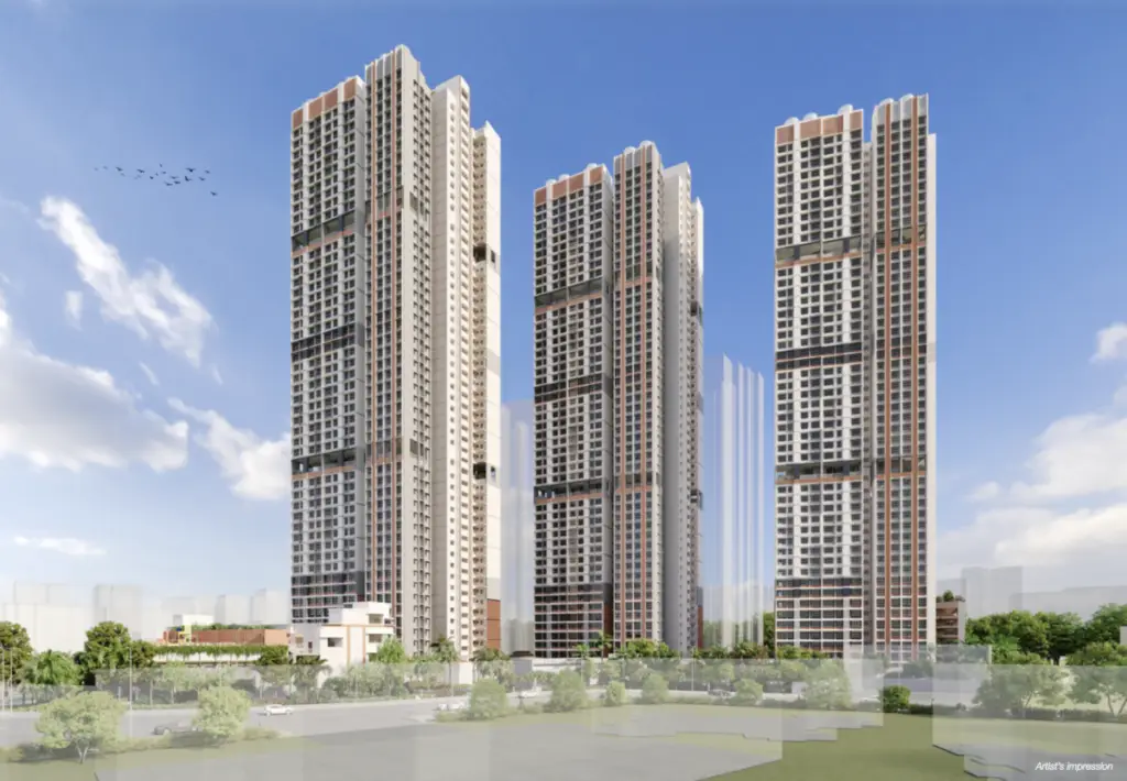 Three tall modern residential towers rise against a blue sky, with trees and a road in the foreground.