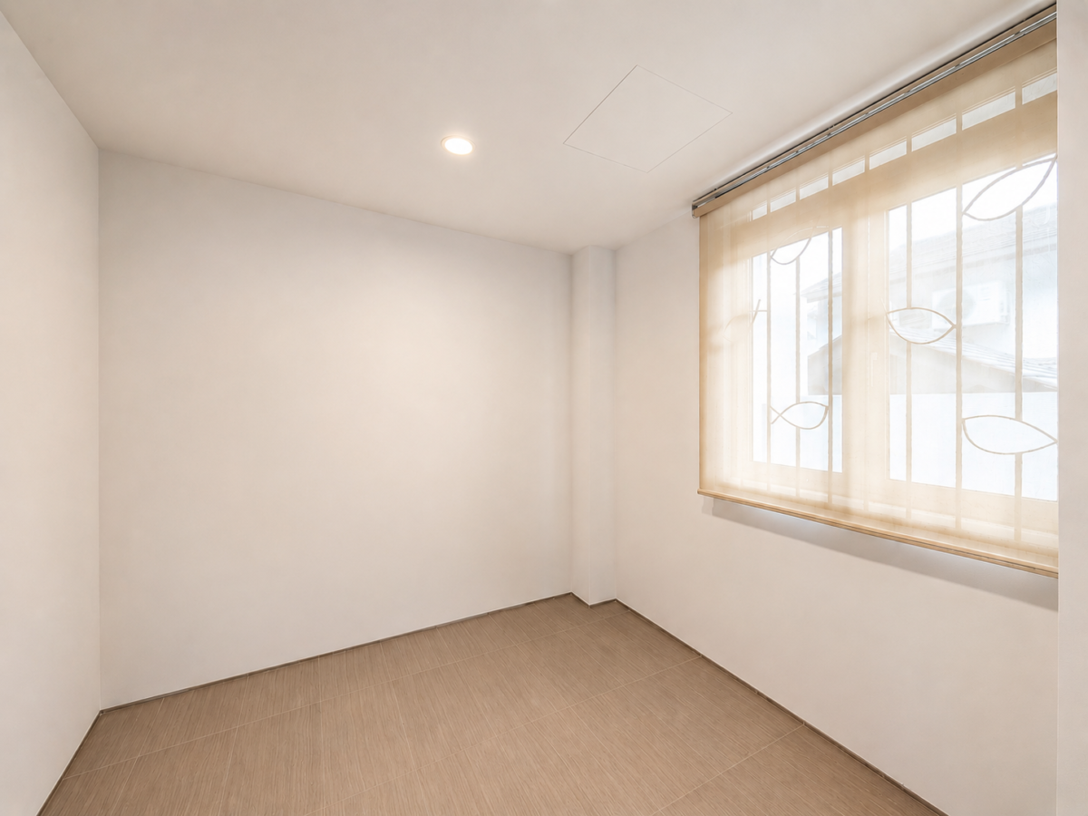 Empty white-walled room with beige tiled floor and a large window covered by sheer blinds letting in soft light