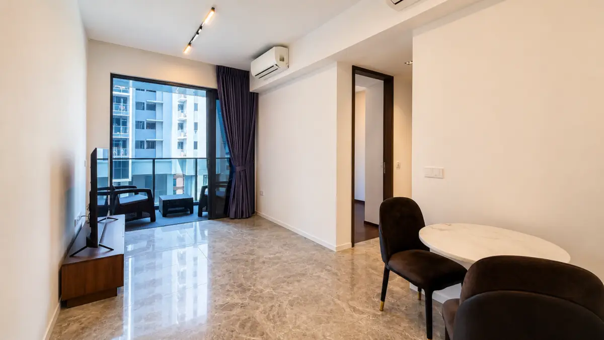Modern living room with marble floor, flat-screen TV on a low stand, and glass balcony doors with purple curtains.